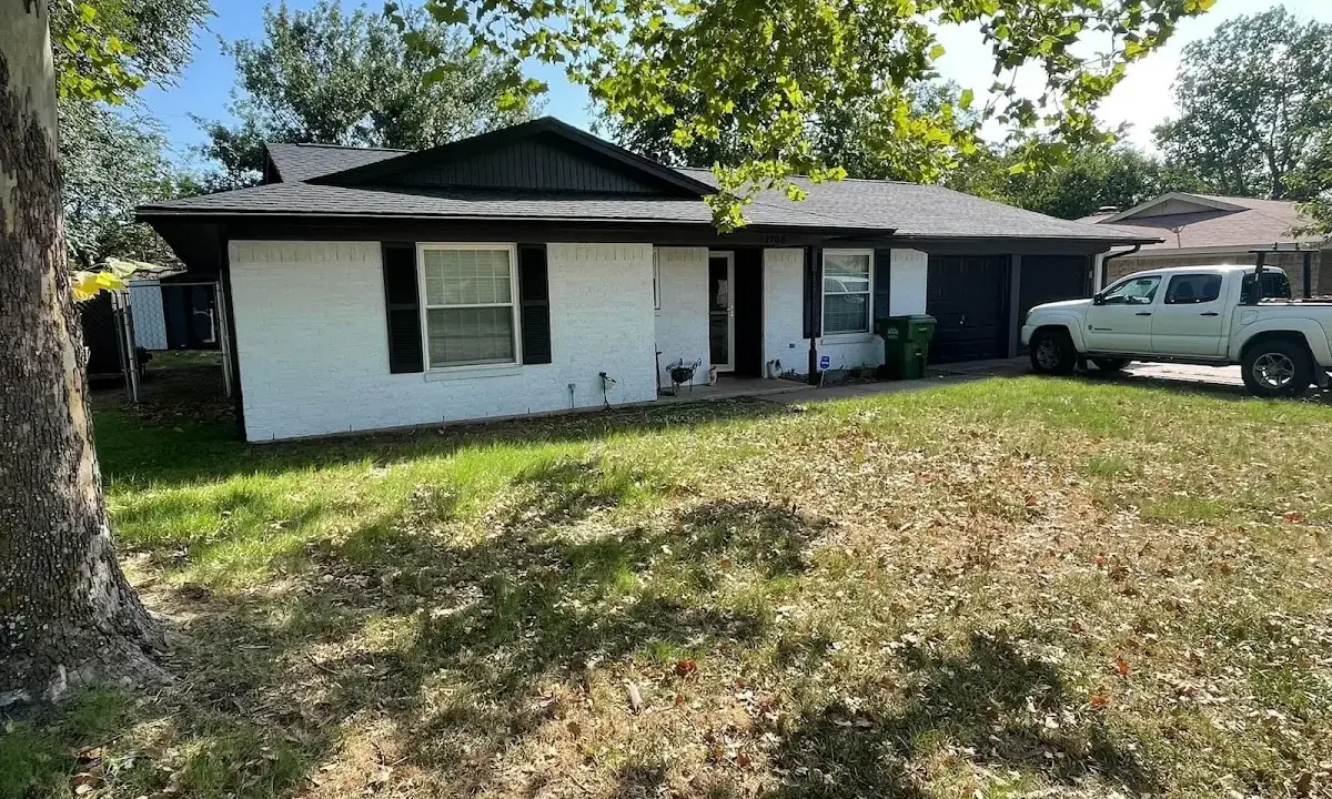 Professional roofing crew working on a residential roof in Greer